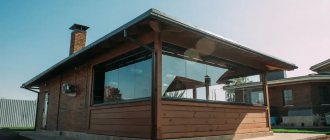 Wooden veranda of a brick summer kitchen photo